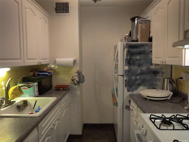 kitchen with white cabinets, decorative backsplash, and sink