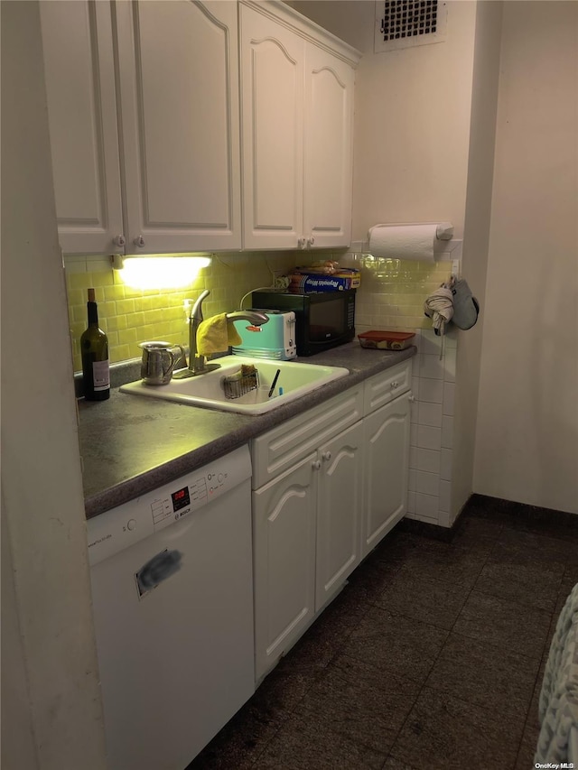 kitchen featuring white dishwasher, backsplash, white cabinets, and sink