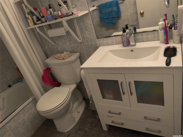 bathroom with decorative backsplash, vanity, toilet, and tile walls