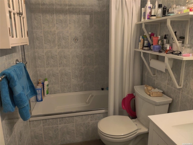 full bathroom featuring vanity, toilet, shower / bath combo with shower curtain, and tile walls