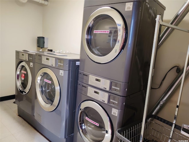 clothes washing area featuring stacked washer / dryer