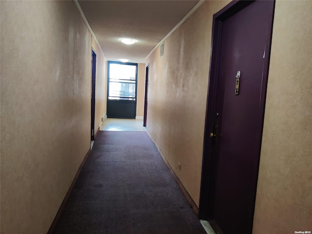 hall with carpet and ornamental molding