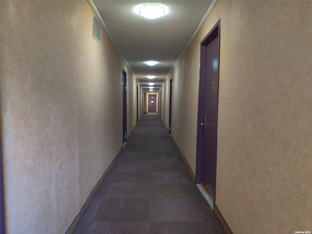 corridor featuring ornamental molding and a textured ceiling