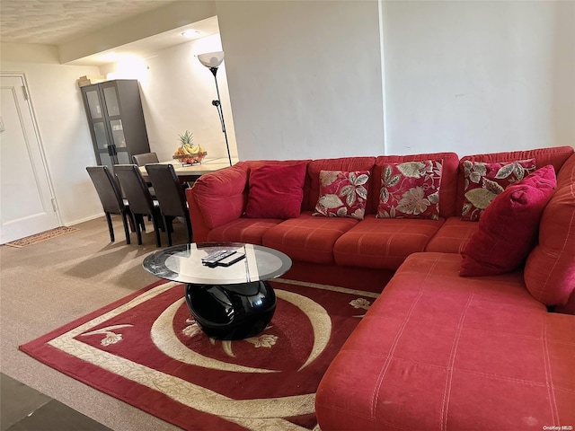 living room featuring carpet and a textured ceiling