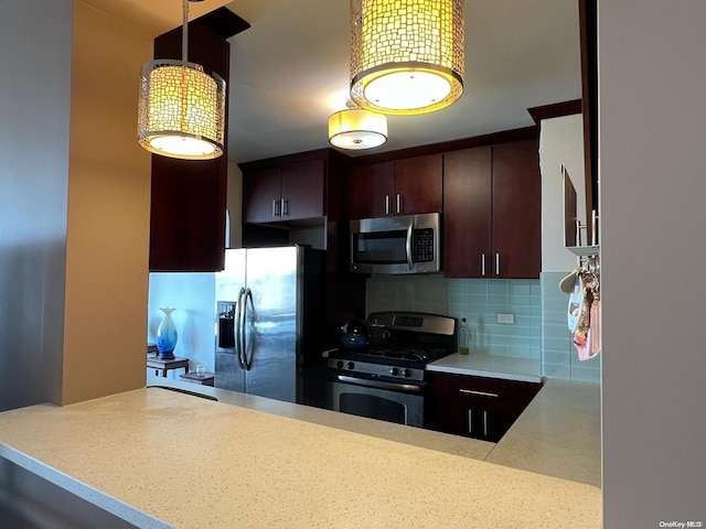 kitchen featuring kitchen peninsula, pendant lighting, stainless steel appliances, and tasteful backsplash