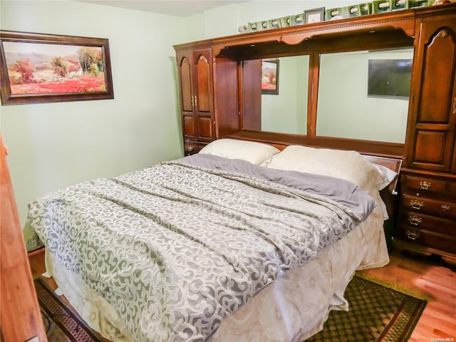 bedroom with hardwood / wood-style floors