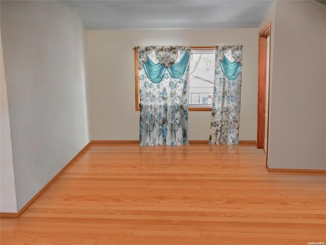 unfurnished room with light hardwood / wood-style flooring