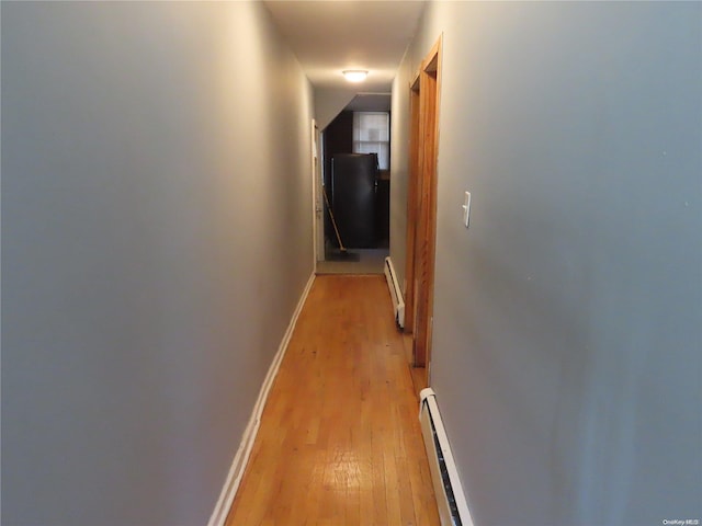 hallway featuring light hardwood / wood-style flooring and a baseboard radiator