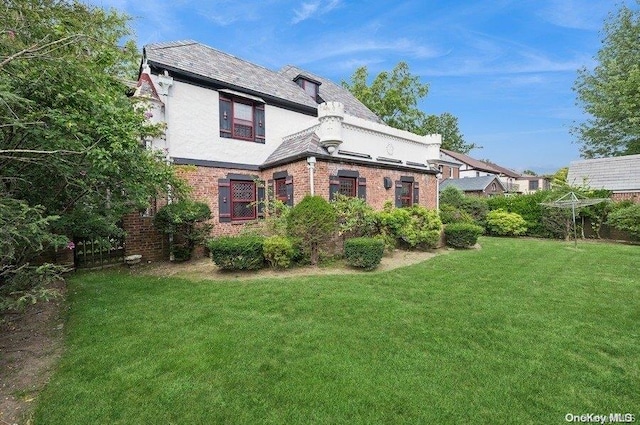 rear view of property featuring a yard