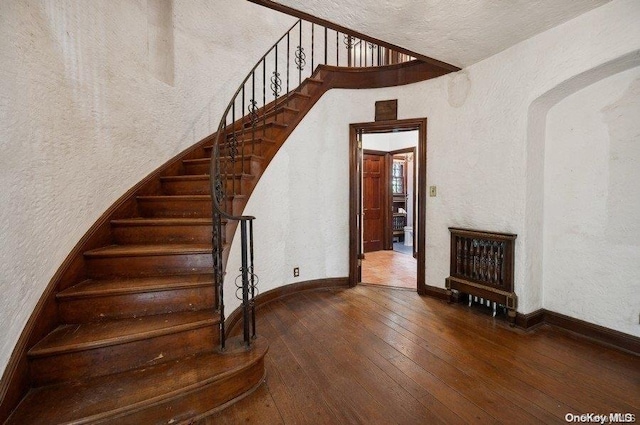 stairs with hardwood / wood-style flooring
