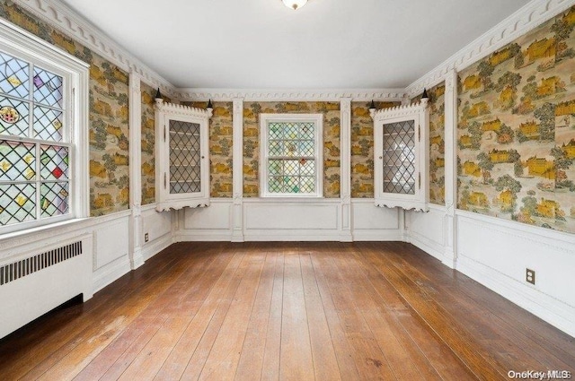 unfurnished sunroom with a wealth of natural light and radiator heating unit