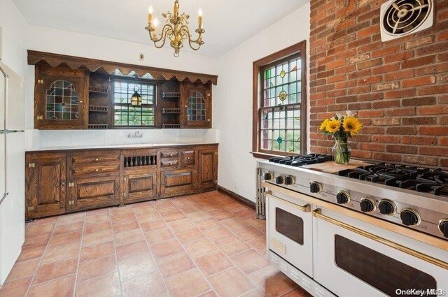 29-37 168th St, Flushing, NY 11358 - kitchen with double oven range, a chandelier, light tile patterned flooring, and healthy amount of natural light