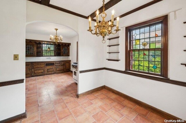 29-37 168th St, Flushing, NY 11358 - unfurnished dining area with a chandelier, arched walkways, baseboards, crown molding, and light tile patterned flooring