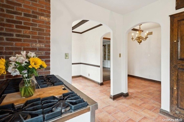 kitchen with light tile patterned floors and a chandelier