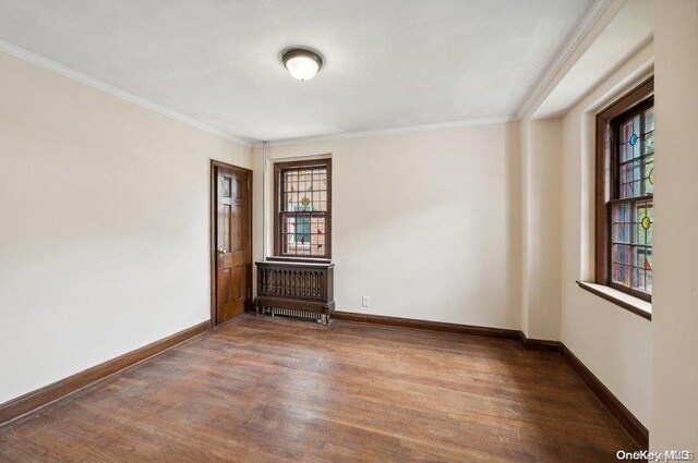 29-37 168th St, Flushing, NY 11358 - spare room featuring wood finished floors, crown molding, and baseboards