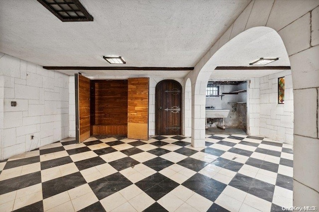 unfurnished room with a textured ceiling
