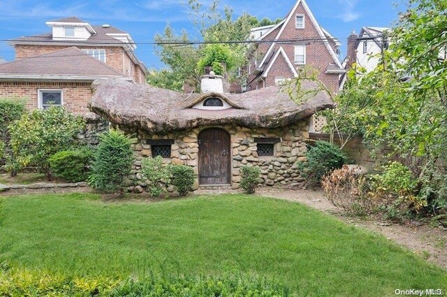29-37 168th St, Flushing, NY 11358 - tudor home with a front lawn and a chimney