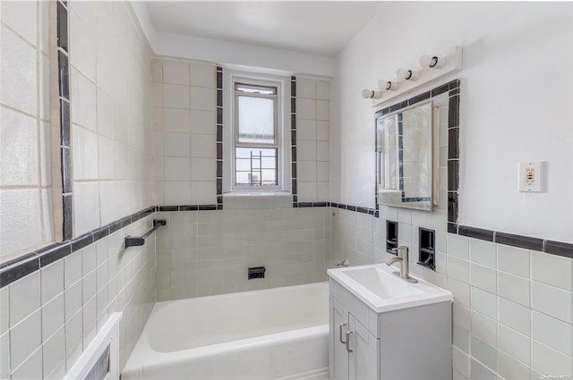 bathroom featuring vanity, a bath, and tile walls