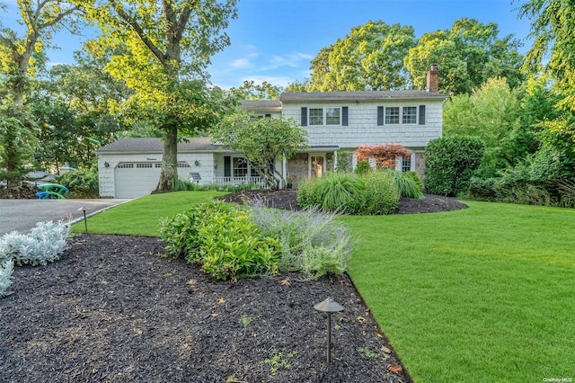 view of front facade with a garage and a front lawn