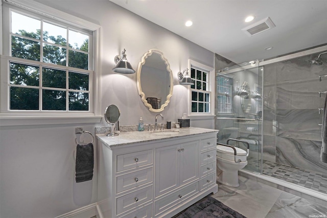 bathroom featuring a shower with door, vanity, and toilet