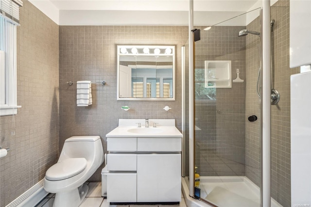 bathroom with vanity, a shower with door, tile walls, tile patterned flooring, and toilet