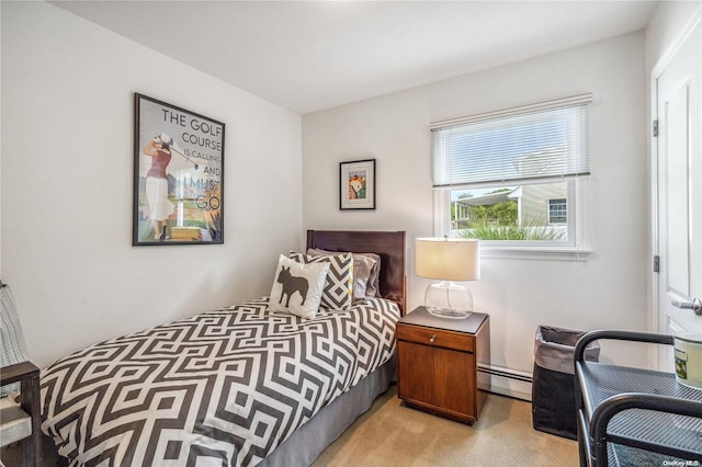 bedroom with light colored carpet and baseboard heating