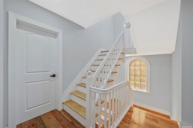 stairs featuring wood-type flooring