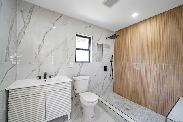 bathroom featuring vanity, toilet, and a shower