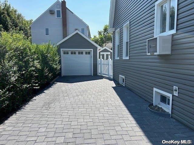 view of side of home featuring an outdoor structure and a garage