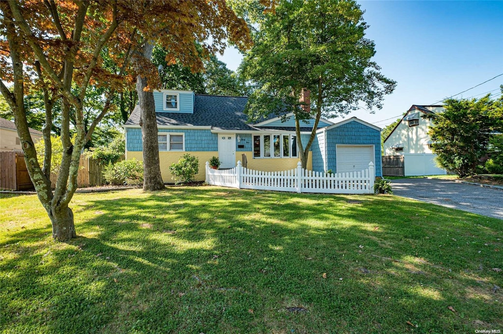 view of front of home featuring a garage and a front lawn