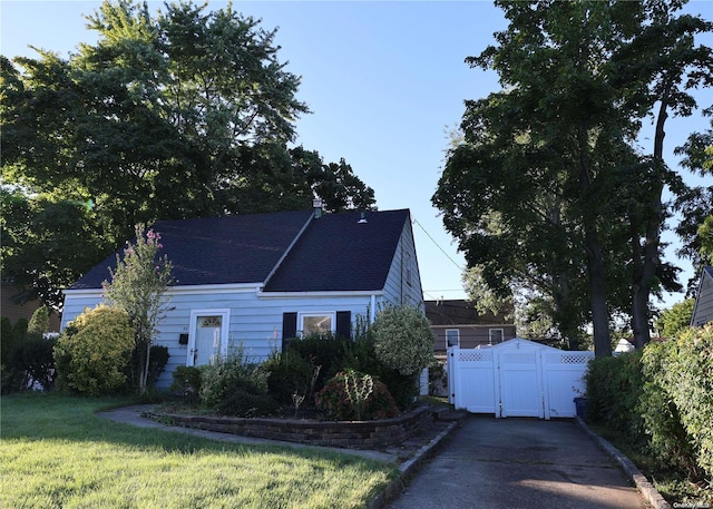 cape cod home with a front yard