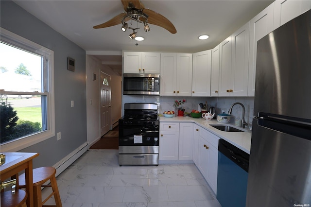 kitchen featuring stainless steel appliances, a baseboard radiator, white cabinetry, and sink