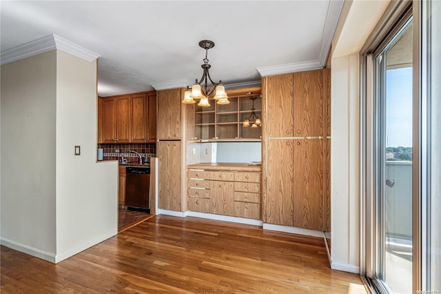 kitchen with ornamental molding, an inviting chandelier, stainless steel dishwasher, and wood-type flooring