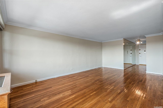 empty room with crown molding and dark hardwood / wood-style flooring