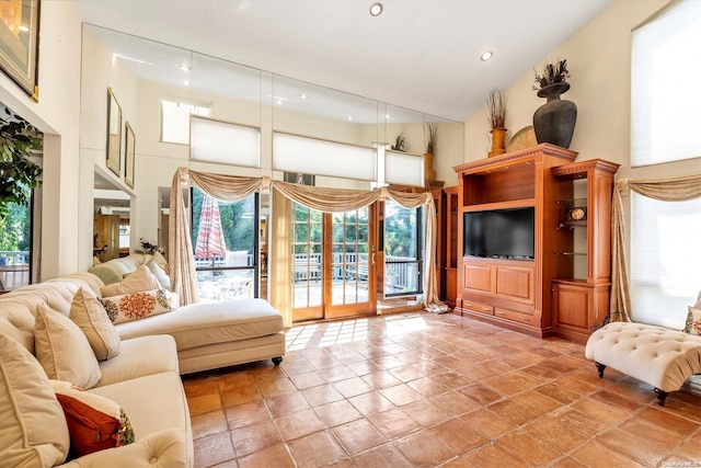 living room featuring a towering ceiling and french doors