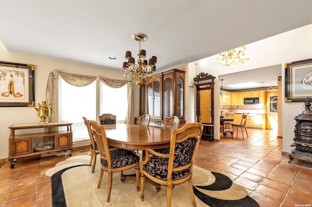 dining room featuring light tile patterned floors and an inviting chandelier