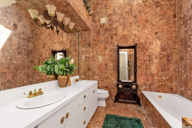 bathroom featuring vanity, toilet, tile walls, a notable chandelier, and tiled bath