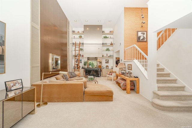 living room featuring light carpet and a high ceiling