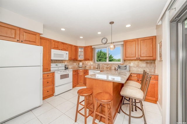 kitchen featuring light stone countertops, tasteful backsplash, white appliances, a kitchen bar, and light tile patterned floors