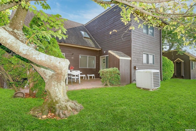 back of house featuring a patio, cooling unit, and a lawn