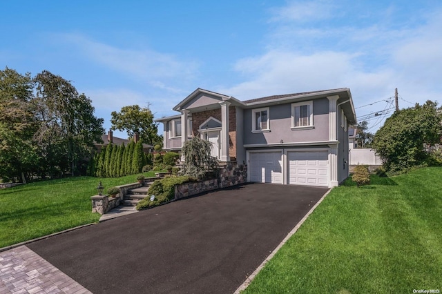 split foyer home featuring a front lawn and a garage