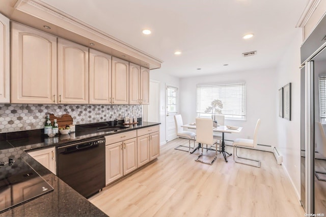 kitchen with dark stone counters, black appliances, sink, decorative backsplash, and light wood-type flooring