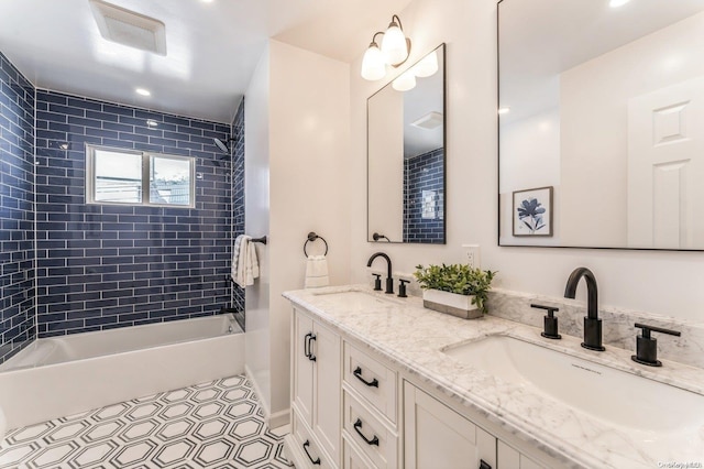 bathroom featuring tile patterned floors, vanity, and tiled shower / bath