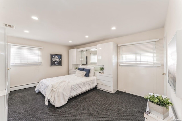 carpeted bedroom featuring baseboard heating