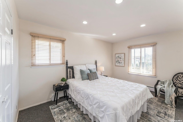 carpeted bedroom featuring multiple windows