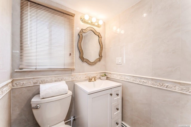 bathroom featuring vanity, plenty of natural light, and tile walls