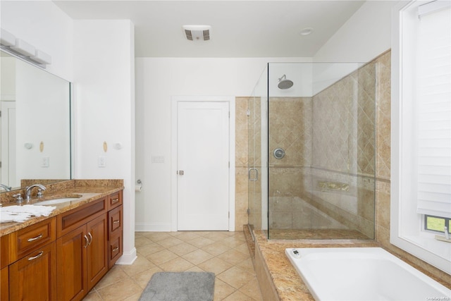 bathroom with tile patterned floors, vanity, and shower with separate bathtub