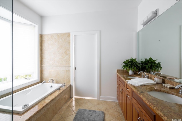 bathroom with vanity, tile patterned floors, and tiled tub