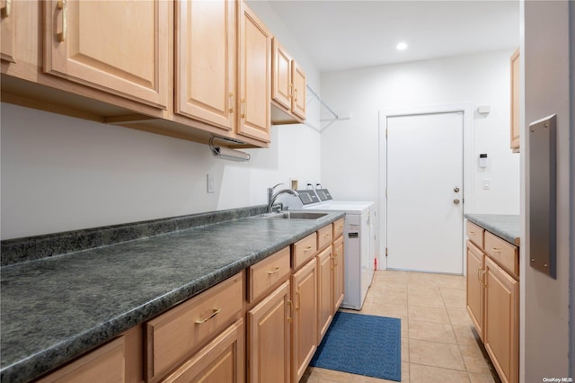 kitchen with light tile patterned floors, light brown cabinets, and separate washer and dryer