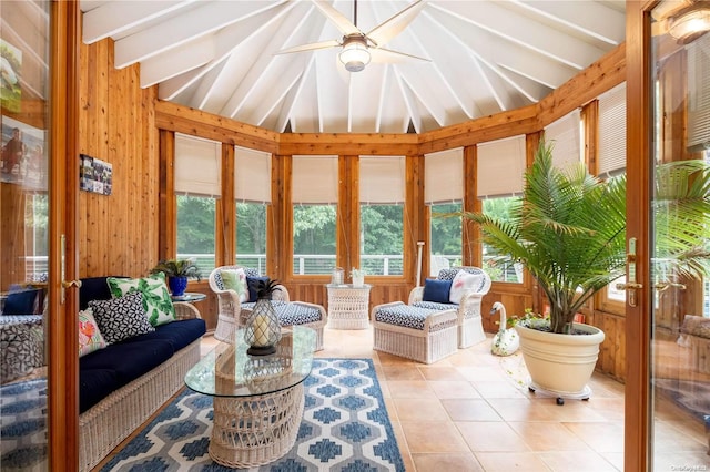 sunroom with ceiling fan and lofted ceiling with beams